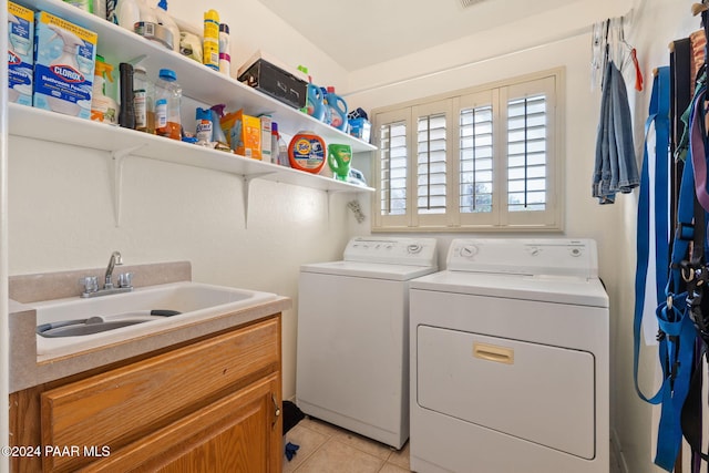 washroom with washer and dryer, light tile patterned floors, and sink