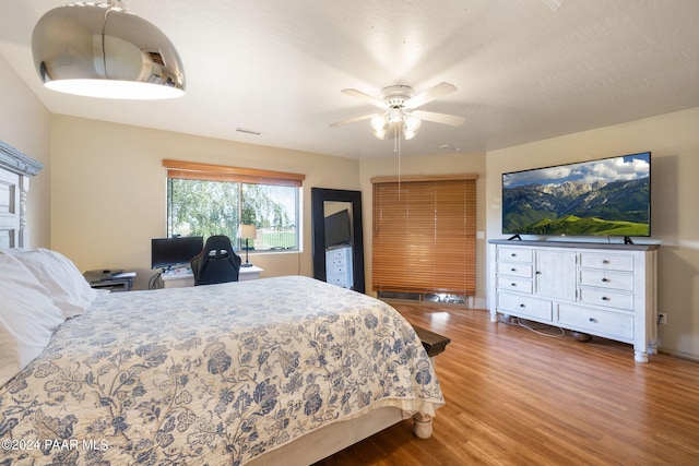 bedroom with hardwood / wood-style flooring and ceiling fan