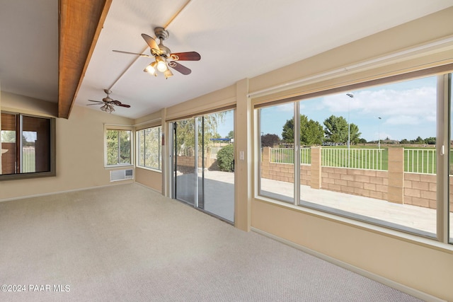 unfurnished sunroom featuring lofted ceiling with beams and ceiling fan