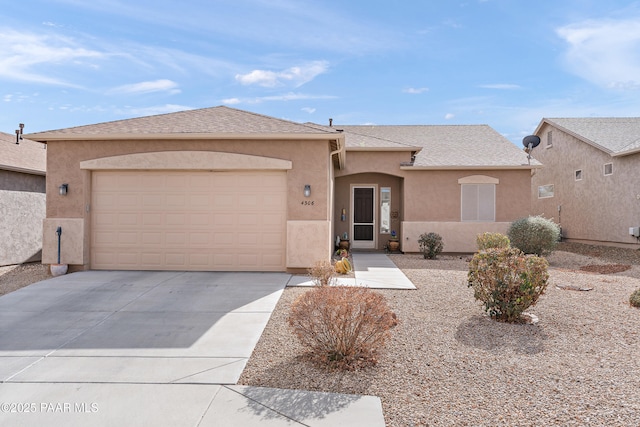 view of front of property with a garage, roof with shingles, driveway, and stucco siding