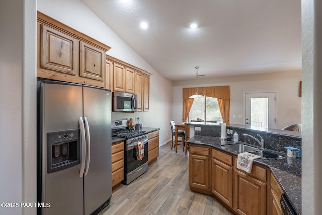 10559 Manzanita Trl, Dewey-Humboldt, AZ 86327 - kitchen featuring lofted ceiling, light hardwood / wood-style flooring, appliances with stainless steel finishes, decorative light fixtures, and dark stone counters