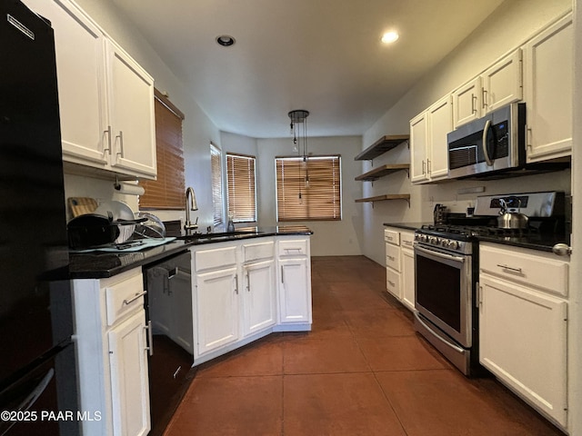 kitchen featuring pendant lighting, black appliances, white cabinets, sink, and kitchen peninsula