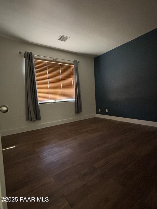 unfurnished room featuring dark hardwood / wood-style flooring