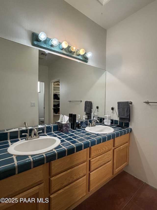 bathroom with tile patterned floors, vanity, and toilet