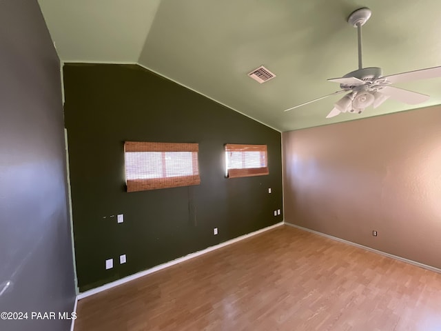 spare room featuring hardwood / wood-style flooring, ceiling fan, and lofted ceiling