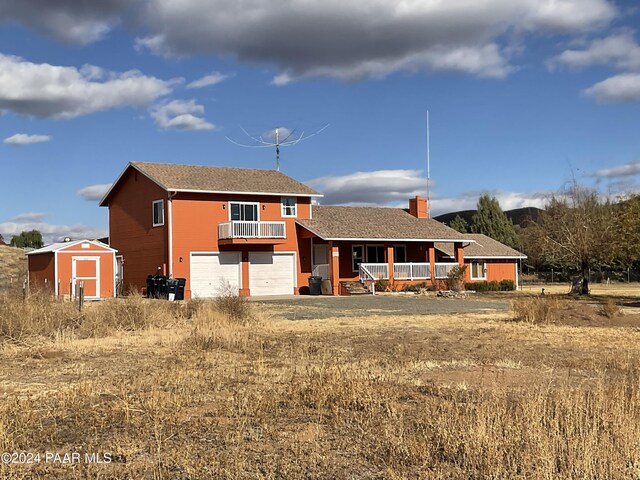 view of front of property with a porch and a garage