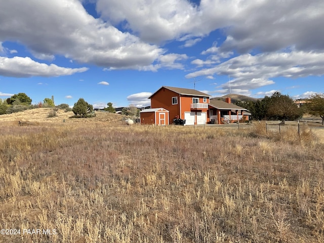 back of property with a rural view