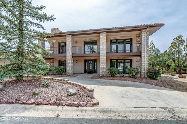 285 E Crestwood, Prescott, AZ 86303 - view of front of home featuring a balcony, a chimney, and brick siding