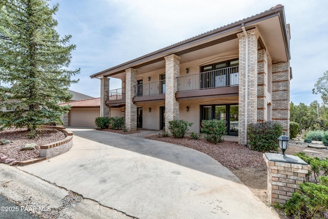 285 E Crestwood, Prescott, AZ 86303 - view of front of property featuring a balcony, stucco siding, a garage, and brick siding