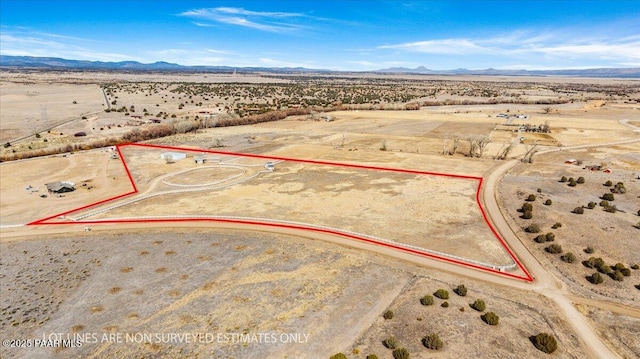 drone / aerial view featuring a desert view and a mountain view