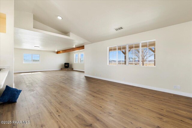 unfurnished living room featuring recessed lighting, wood finished floors, visible vents, baseboards, and vaulted ceiling