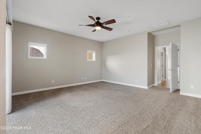 empty room with light carpet, ceiling fan, and a healthy amount of sunlight