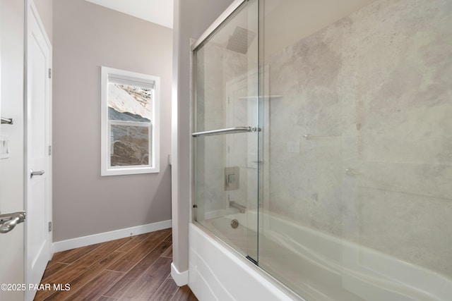 bathroom featuring combined bath / shower with glass door