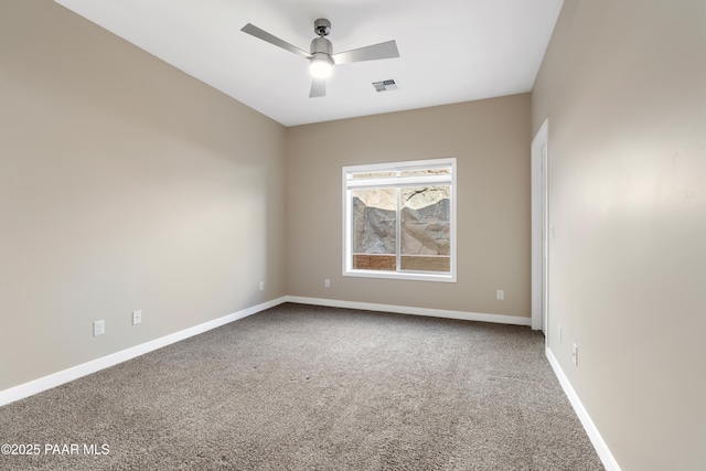 carpeted spare room featuring ceiling fan