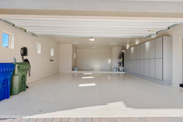 garage featuring a garage door opener and water heater