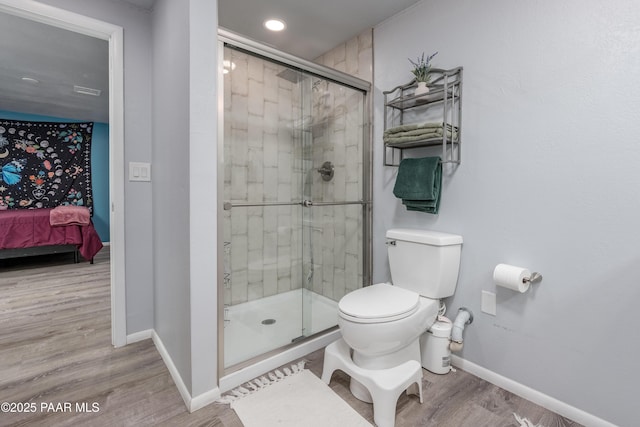 225 Sierra Rd, Sedona, AZ 86336 - bathroom with baseboards, a shower stall, toilet, wood finished floors, and connected bathroom