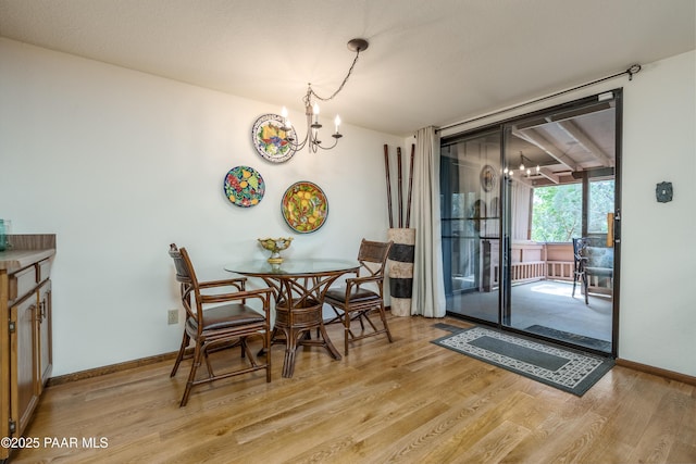 225 Sierra Rd, Sedona, AZ 86336 - dining space featuring a chandelier, light wood finished floors, and baseboards