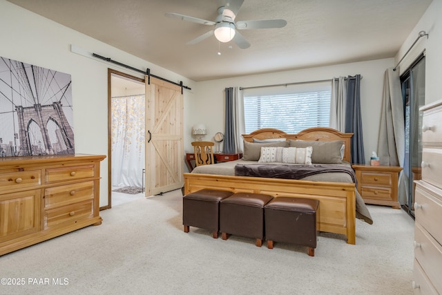 225 Sierra Rd, Sedona, AZ 86336 - bedroom with a barn door, light carpet, ceiling fan, and access to outside