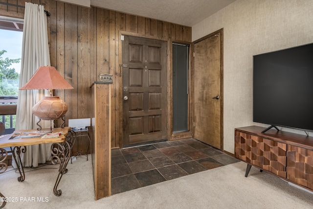 225 Sierra Rd, Sedona, AZ 86336 - carpeted entryway featuring wooden walls and stone finish floors