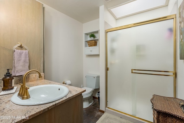 225 Sierra Rd, Sedona, AZ 86336 - bathroom featuring a shower stall, toilet, vanity, built in shelves, and stone finish floors