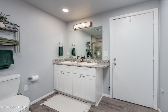 225 Sierra Rd, Sedona, AZ 86336 - full bathroom featuring toilet, a shower stall, wood finished floors, baseboards, and double vanity