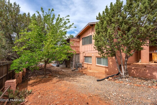 225 Sierra Rd, Sedona, AZ 86336 - back of house featuring board and batten siding, fence, and central AC unit