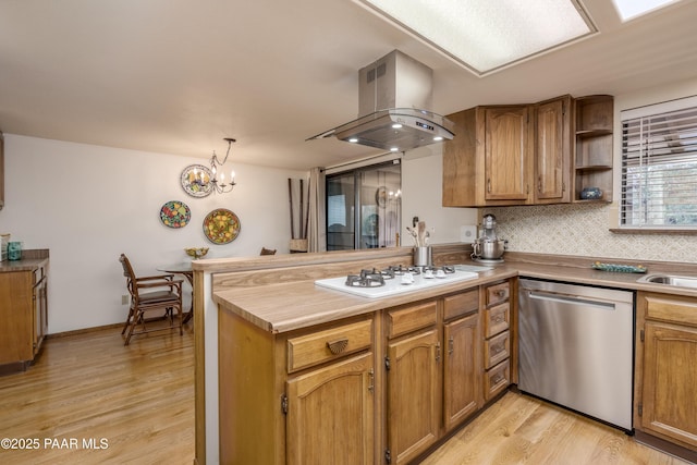 225 Sierra Rd, Sedona, AZ 86336 - kitchen featuring dishwasher, island range hood, white cooktop, a peninsula, and brown cabinetry