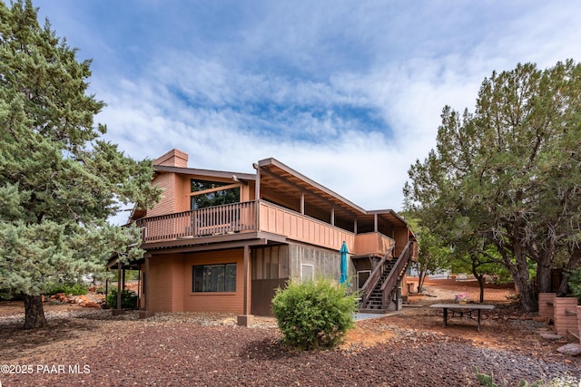225 Sierra Rd, Sedona, AZ 86336 - back of house with stairway, a wooden deck, and a chimney