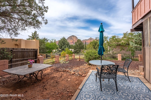 225 Sierra Rd, Sedona, AZ 86336 - view of yard featuring outdoor dining space, fence, a patio area, and a mountain view