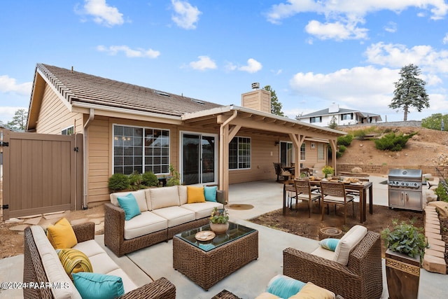 rear view of house featuring a patio area and an outdoor living space