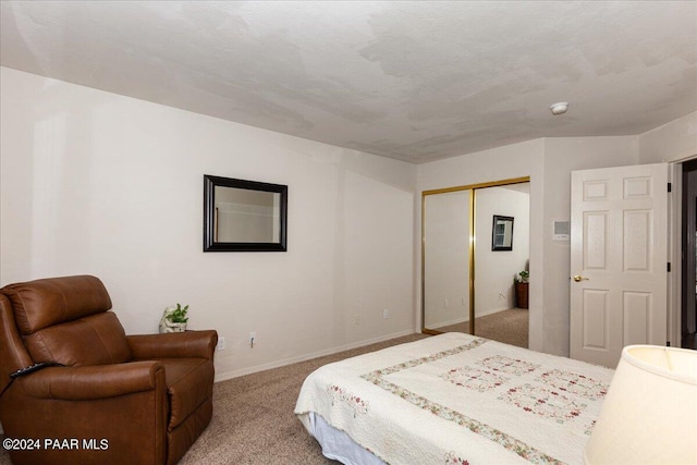 bedroom featuring light carpet, a closet, and a textured ceiling