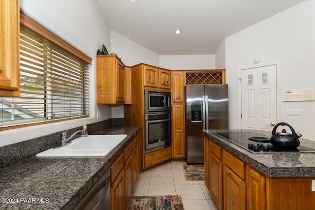 kitchen with light tile patterned floors, sink, and appliances with stainless steel finishes