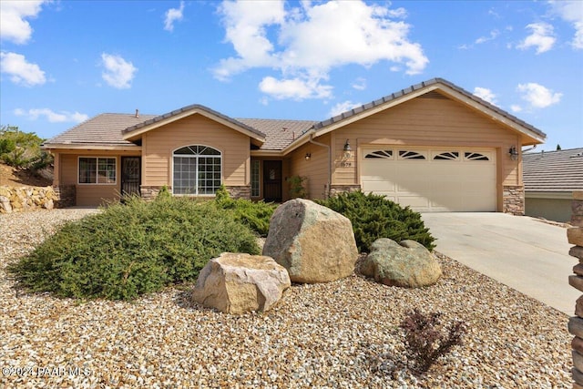 ranch-style home featuring a garage