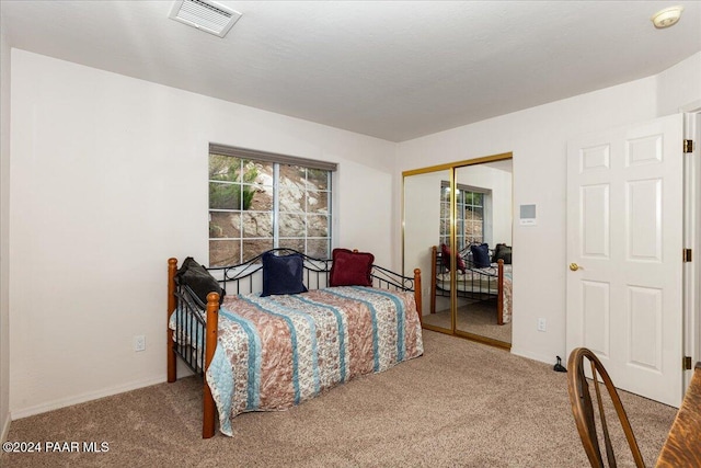 carpeted bedroom with a closet