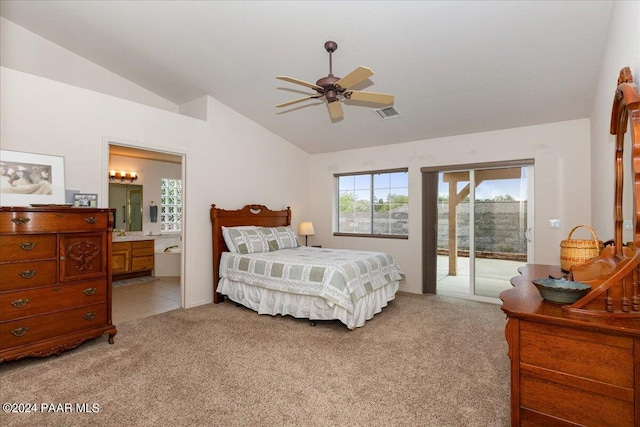 bedroom featuring lofted ceiling, light carpet, access to outside, and ensuite bath