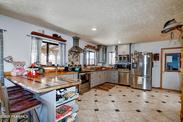 24585 N Catalina St, Paulden, AZ 86334 - kitchen featuring stainless steel appliances, gray cabinets, a sink, island exhaust hood, and a textured ceiling