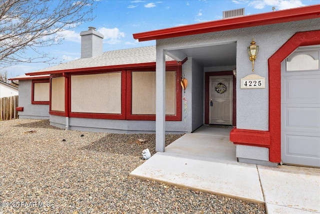 property entrance with a chimney