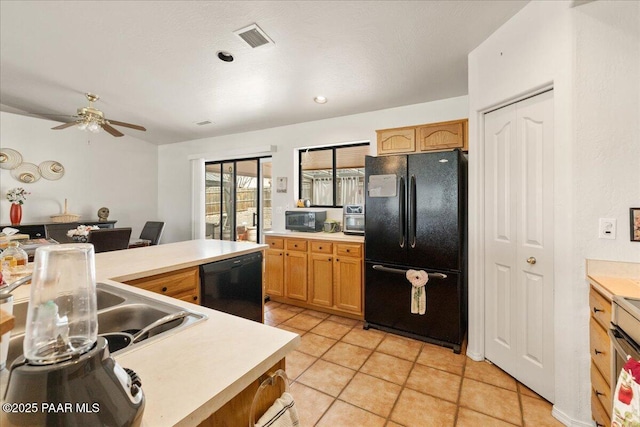 kitchen featuring visible vents, light tile patterned flooring, light countertops, a ceiling fan, and black appliances