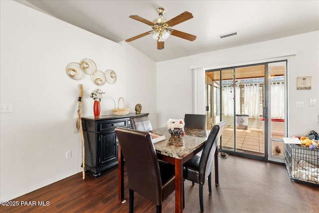dining space featuring visible vents, baseboards, ceiling fan, dark wood-style floors, and vaulted ceiling