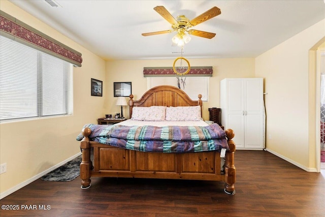 bedroom with baseboards, ceiling fan, and dark wood-type flooring