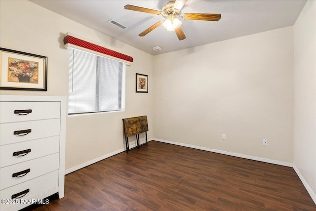 unfurnished bedroom with baseboards, ceiling fan, wood finished floors, and visible vents