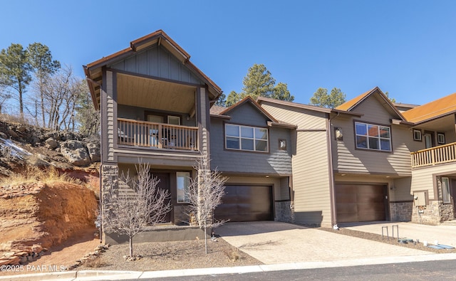 view of front of property with a balcony, driveway, and a garage