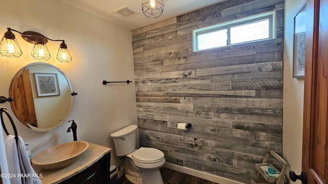 bathroom with hardwood / wood-style floors, vanity, and toilet