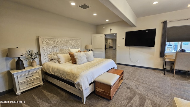 bedroom with beam ceiling and carpet floors