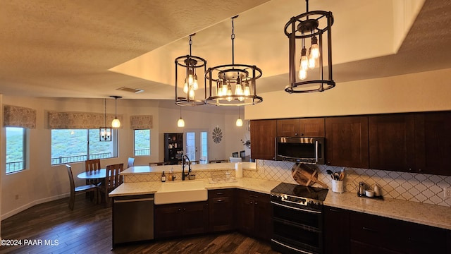 kitchen with backsplash, sink, dark wood-type flooring, and appliances with stainless steel finishes