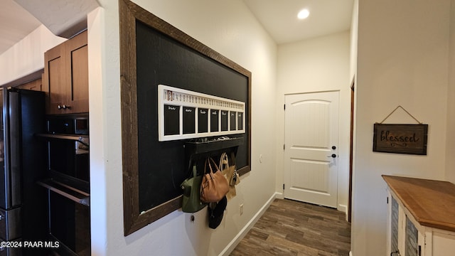 interior space with hardwood / wood-style flooring and black fridge