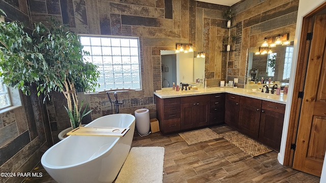 bathroom featuring hardwood / wood-style floors, a washtub, tile walls, and vanity