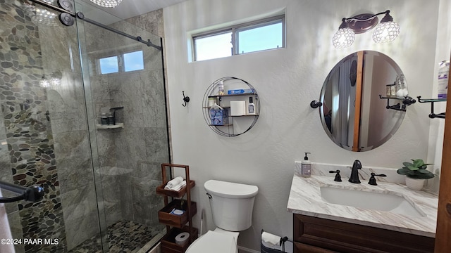 bathroom with vanity, toilet, and walk in shower