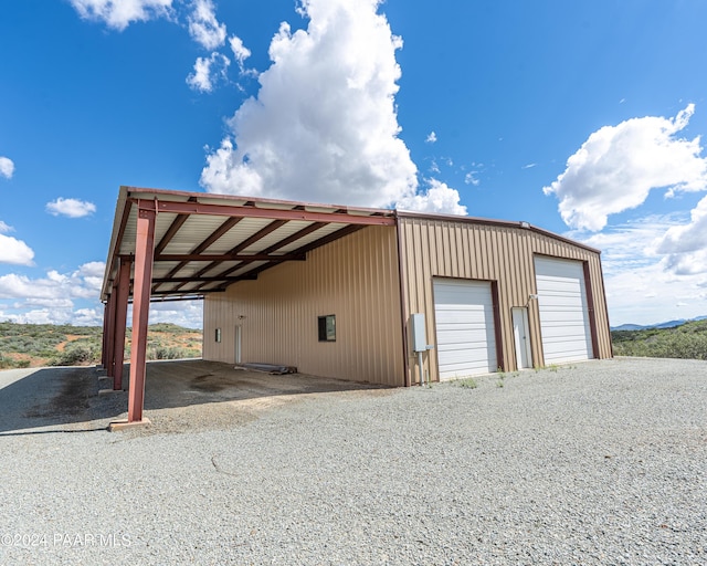 view of outdoor structure featuring a carport and a garage