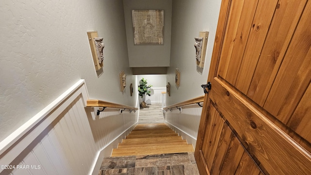 stairs featuring wood-type flooring